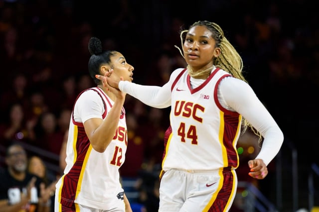 USC guard JuJu Watkins (12) celebrates with forward Kiki Iriafen (44) during the first half of an NCAA college basketball game against Illinois, Sunday, Feb. 23, 2025, in Los Angeles. (AP Photo/William Liang)
