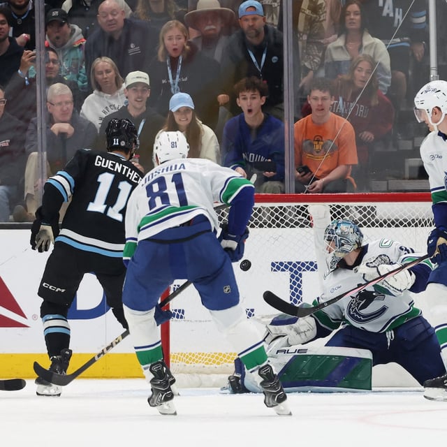 Feb 23, 2025; Salt Lake City, Utah, USA; Utah Hockey Club right wing Dylan Guenther (11) scores a goal against Vancouver Canucks goaltender Arturs Silovs (31) during the third period at Delta Center. Mandatory Credit: Rob Gray-Imagn Images