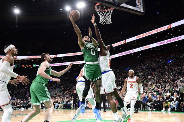 Feb 23, 2025; Boston, Massachusetts, USA; Boston Celtics forward Jayson Tatum (0) shoots the ball over New York Knicks forward OG Anunoby (8) during the second half at TD Garden. Mandatory Credit: Bob DeChiara-Imagn Images