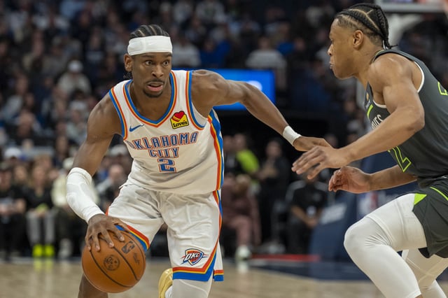 Feb 23, 2025; Minneapolis, Minnesota, USA; Oklahoma City Thunder guard Shai Gilgeous-Alexander (2) dribbles the ball past Minnesota Timberwolves guard Jaylen Clark (22) in the first half at Target Center. Mandatory Credit: Jesse Johnson-Imagn Images