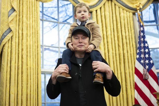 Elon Musk carries his son X Æ A-Xii on his shoulders in the Oval Office of the White House in Washington, DC, on February 11, 2025.