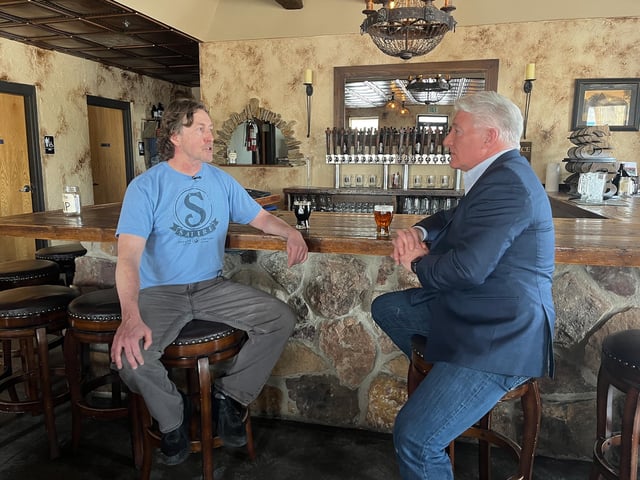Satire Brewing owner Todd Waufle talks with John King in Thornton, Colorado.