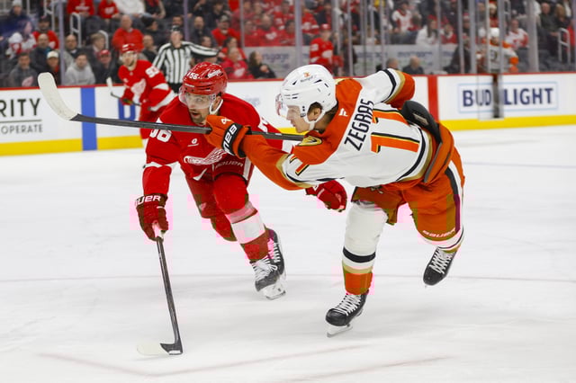 Feb 23, 2025; Detroit, Michigan, USA; Anaheim Ducks center Trevor Zegras (11) takes a shot on goal during the first period of the game between the Detroit Red Wings and the Anaheim Ducks at Little Caesars Arena. Mandatory Credit: Brian Bradshaw Sevald-Imagn Images