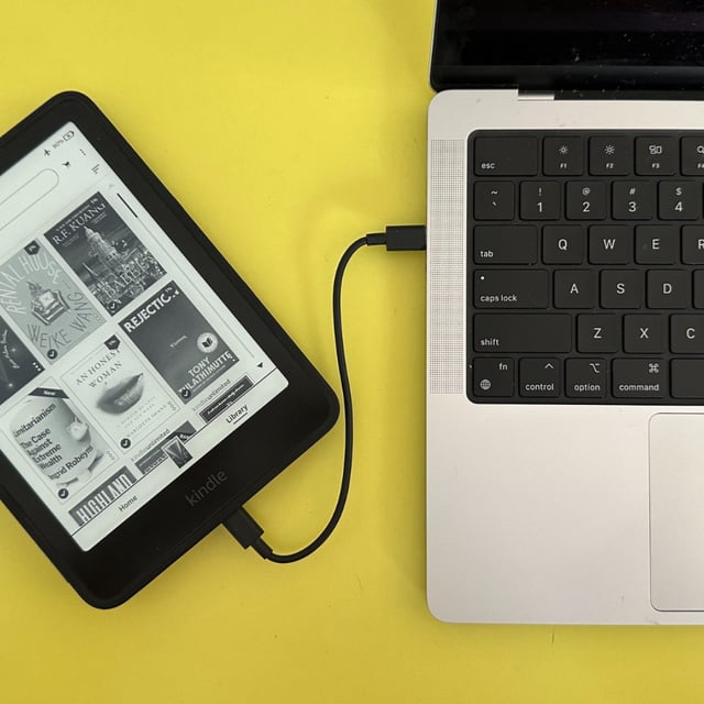 A Kindle plugged into a MacBook