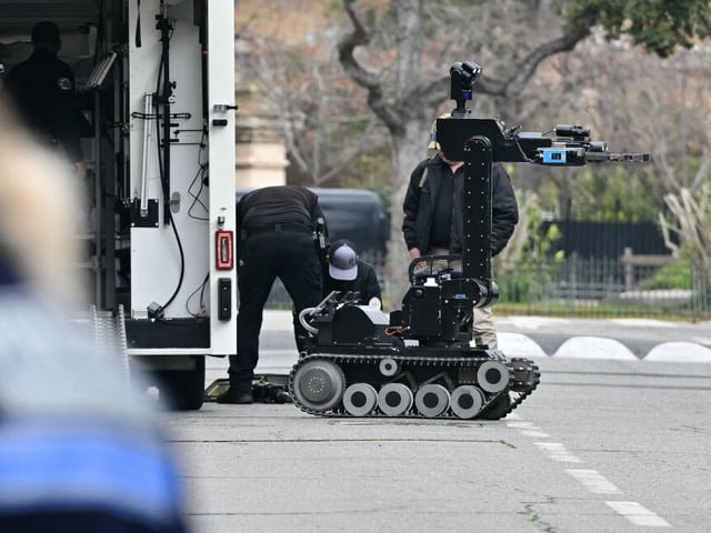 Bomb-squad officers prepare a demining robot in front of the Russian consulate in Marseille, after three improvised explosive devices were thrown, on February 24, 2025. No one was injured, and only two of the three devices detonated in the attack on the third anniversary of Russia's full-scale invasion of Ukraine, a police source said. (Photo by Miguel MEDINA / AFP) (Photo by MIGUEL MEDINA/AFP via Getty Images)