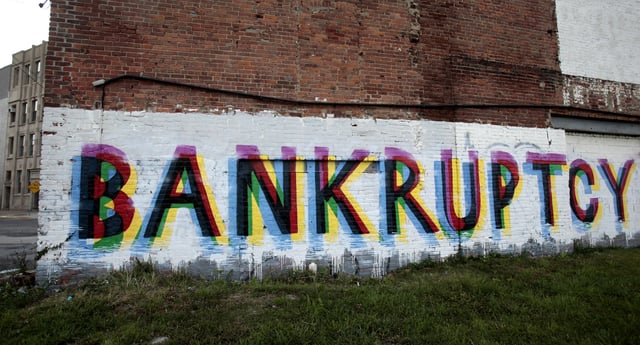 The word 'Bankruptcy' is seen painted on the side of a vacant building by street artists as a statement on the financial affairs of the city on Grand River Avenue in Detroit, Michigan July 26, 2013.  REUTERS/Rebecca Cook/File Photo
