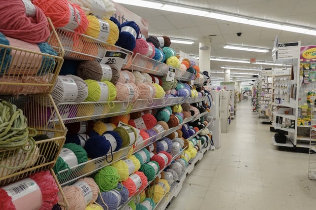 Rolls of yarn fill a shelf in a JOANN Fabric and Crafts store slated to close on February 13, 2025 in Miami, Florida.
