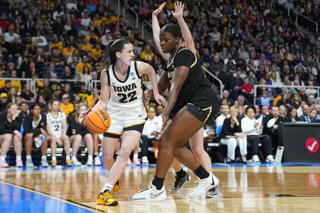 Mar 30, 2024; Albany, NY, USA; Iowa Hawkeyes guard Caitlin Clark (22) dribbles the ball past Colorado Buffaloes center Aaronette Vonleh (21) in the semifinals of the Albany Regional of the 2024 NCAA Tournament at the MVP Arena. Mandatory Credit: Gregory Fisher-USA TODAY Sports/File Photo