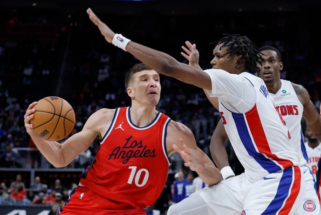 Clippers guard Bogdan Bogdanovic looks to pass the ball as Detroit Pistons forward Ausar Thompson, front right, defends during the second half on Monday night in Detroit. Bogdanovic had 13 points and five assists but battled foul trouble and struggled with his shot in a 106-97 loss. (AP Photo/Duane Burleson)