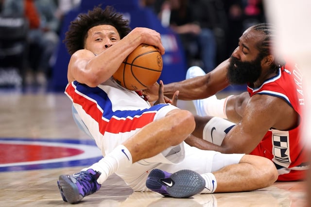 Cade Cunningham of the Detroit Pistons dives on the floor for a loose ball against James Harden of the LA Clippers during Monday's game.