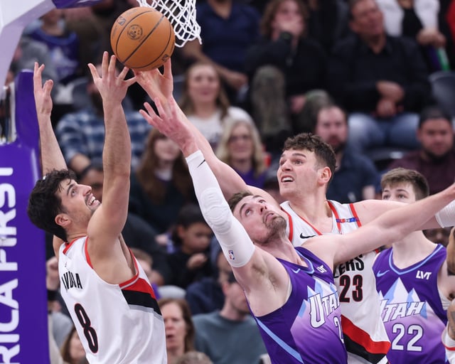 Feb 24, 2025; Salt Lake City, Utah, USA; Utah Jazz center Micah Potter (25) battle for a rebound against Portland Trail Blazers forward Deni Avdija (8) and center Donovan Clingan (23) during the second half at Delta Center. Mandatory Credit: Rob Gray-Imagn Images