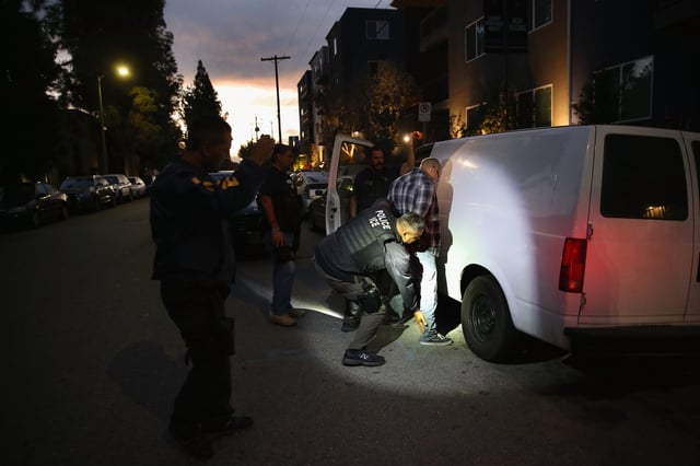 A man is detained by Immigration and Customs Enforcement (ICE), agents early on October 14, 2015 in Los Angeles, California.