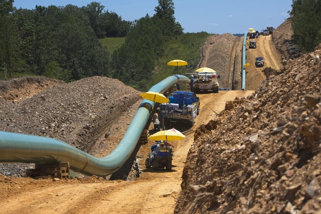 Workers welding pipe together during natural gas pipeline construction in Mississippi countryside outside of Vicksburg.