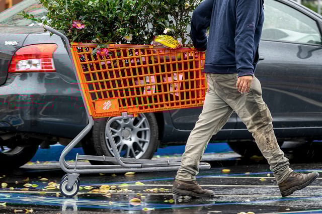 A customer pulls a shopping cart outside a Home Depot store in Palo Alto, California, US, on Monday, Nov. 11, 2024.