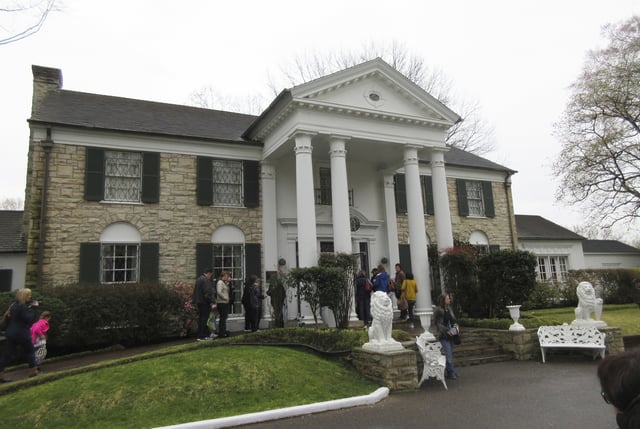 FILE - This March 13, 2017 photo shows visitors getting ready to tour Graceland in Memphis, Tenn. The head of the company that controls Graceland says he is not threatening to move the Memphis, Tennessee-based tourist attraction centered on the life of singer Elvis Presley if city officials do not approve an expansion plan including tax-based incentives. (AP Photo/Beth J. Harpaz, File)