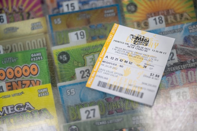 In this photo illustration, a lottery ticket is shown on a Chevron gas station countertop on July 28, 2022 in Houston, Texas.
