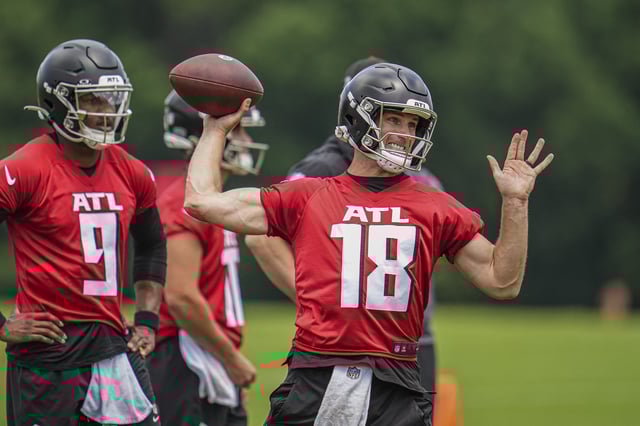 Jun 3, 2024; Atlanta, GA, USA; Atlanta Falcons quarterback Kirk Cousins (18) throws while quarterback Michael Penix Jr (9) watches on the field during Falcons OTA at the Falcons Training facility. Mandatory Credit: Dale Zanine-USA TODAY Sports/File Photo