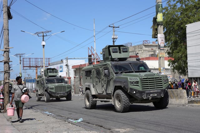 Armored vehicles of the Kenyan peace-keeping mission patrol as residents flee Delmas 30 neighbourhood due to gang violence, in Port-au-Prince, Haiti February 25, 2025. REUTERS/Jean Feguens Regala