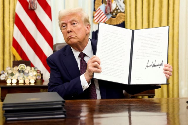 U.S. President Donald Trump holds a signed executive order on AI, in the Oval Office of the White House, in Washington, U.S., January 23, 2025./File Photo/File Photo