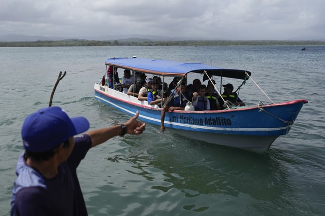 A boat departs to Colombia from Gardi Sugdub on Panama's Caribbean coast, Sunday, Feb. 23, 2025, carrying Venezuelan migrants on their way back from southern Mexico after giving up hopes of reaching the U.S. as President Trump's cracks down on migration.(AP Photo/Matias Delacroix)