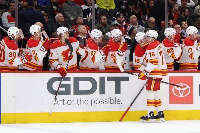 Feb 25, 2025; Washington, District of Columbia, USA; Calgary Flames center Martin Pospisil (76) celebrates with teammates after scoring a goal against the Washington Capitals in the first period at Capital One Arena. Mandatory Credit: Geoff Burke-Imagn Images