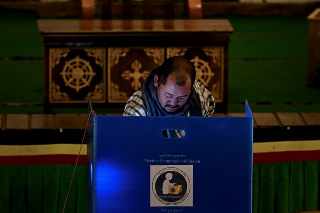 A voter casts his ballot at a polling station during Bhutan's general elections in January  2024