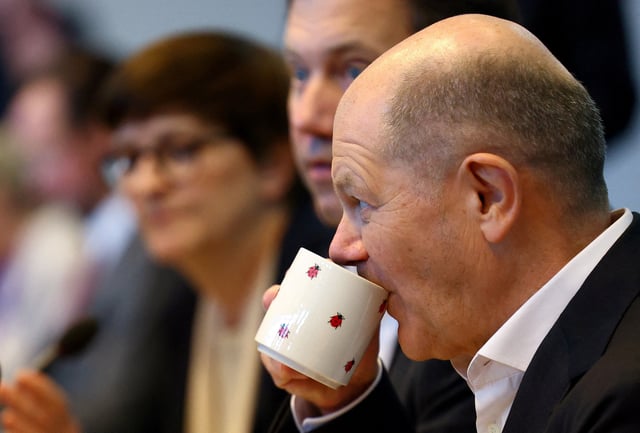 Olaf Scholz, German Chancellor of the Social Democratic Party (SPD) drinks from a mug ahead of the SPD parliamentary fraction meeting following the German general elections in Berlin, Germany, February 25, 2025. REUTERS/Lisi Niesner