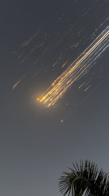 Orange balls of light fly across the sky as debris from the SpaceX Starship that launched Thursday in Texas. The debris was spotted over Turks and Caicos Islands in this screen grab obtained from social media video.