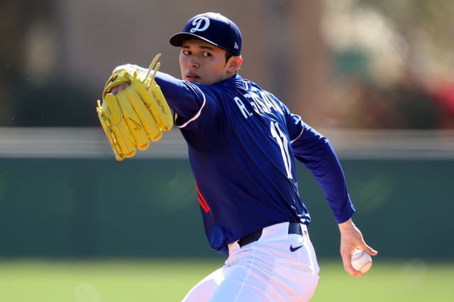 GLENDALE, ARIZONA - FEBRUARY 25: Roki Sasaki #11 of the Los Angeles Dodgers throws during workouts at Camelback Ranch on February 25, 2025 in Glendale, Arizona.