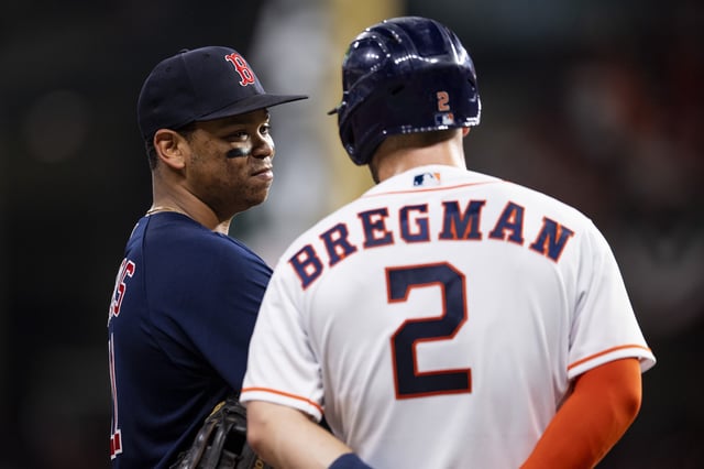 HOUSTON, TX - OCTOBER 22: Rafael Devers #11 of the Boston Red Sox reacts with Alex Bregman #2 of the Houston Astros during the fourth inning of game six of the 2021 American League Championship Series at Minute Maid Park on October 22, 2021 in Houston, Texas.