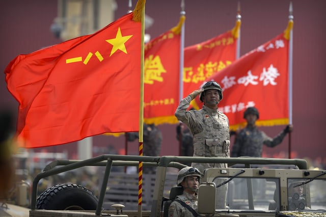 A military officer salutes during a parade to commemorate the 70th anniversary of the founding of the People&#39;s Republic of China in Beijing on October 1, 2019.