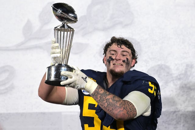 Jan 1, 2024; Pasadena, CA, USA; Michigan Wolverines defensive lineman Mason Graham (55) celebrates with the Leishman Trophy after defeating the Alabama Crimson Tide in the 2024 Rose Bowl college football playoff semifinal game at Rose Bowl. Mandatory Credit: Jayne Kamin-Oncea-USA TODAY Sports