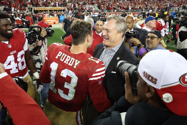 SANTA CLARA, CALIFORNIA - JANUARY 28: Brock Purdy #13 of the San Francisco 49ers celebrates with GM John Lynch after defeating the Detroit Lions 34-31 in the NFC Championship Game at Levi&#39;s Stadium on January 28, 2024 in Santa Clara, California.