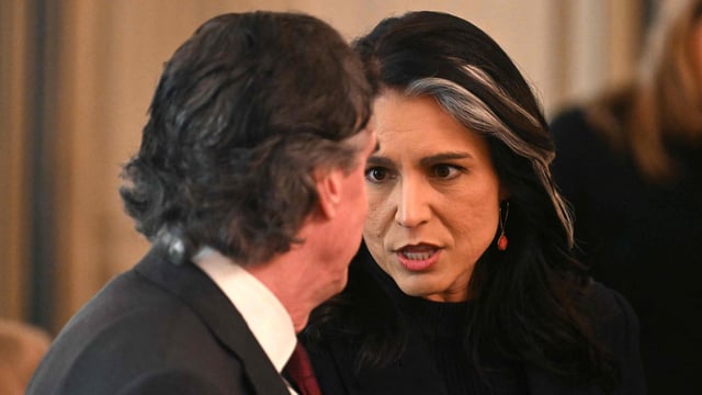 US Secretary of the Interior Doug Burgum (L) speaks with the Director of National Intelligence Tulsi Gabbard, as they attend the Governors Working Session in the State Dining Room of the White House in Washington on February 21.