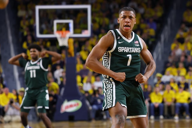 Gehrig Normand #7 of the Michigan State Spartans reacts with Jase Richardson #11 in the second half while playing the Michigan Wolverines at Crisler Arena on February 21, 2025 in Ann Arbor, Michigan. Michigan State won the game 75-62.