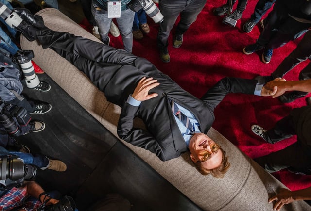 Academy Awards host Conan O'Brien lies over the red carpet during its rollout for the 97th Academy Awards in Los Angeles, California, U.S., February 26, 2025. REUTERS/Carlos Barria     TPX IMAGES OF THE DAY
