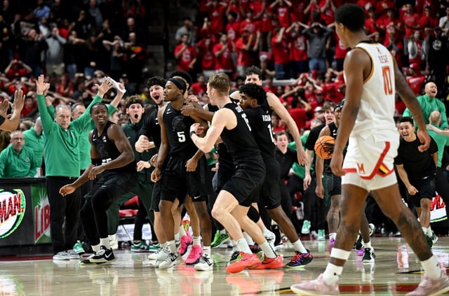 COLLEGE PARK, MARYLAND - FEBRUARY 26: Tre Holloman #5 of the Michigan State Spartans celebrates with teammates after hitting the game winning shot at the buzzer against the Maryland Terrapins at Xfinity Center on February 26, 2025 in College Park, Maryland.  Michigan State won the game 58-55. (Photo by Greg Fiume/Getty Images)