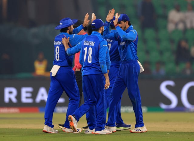 Cricket - ICC Men's Champions Trophy - Group B - England v Afghanistan - Gaddafi Stadium, Lahore, Pakistan - February 26, 2025 Afghanistan's Rahmat Shah and teammates celebrate taking the wicket of England's Jos Buttler REUTERS/Akhtar Soomro
