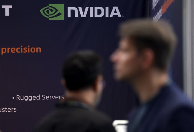 Attendees walk past a banner showing Nvidia branding, during the AI & Big Data Expo 2025 at the Olympia, in London, Britain, February 5, 2025. REUTERS/Isabel Infantes/File Photo