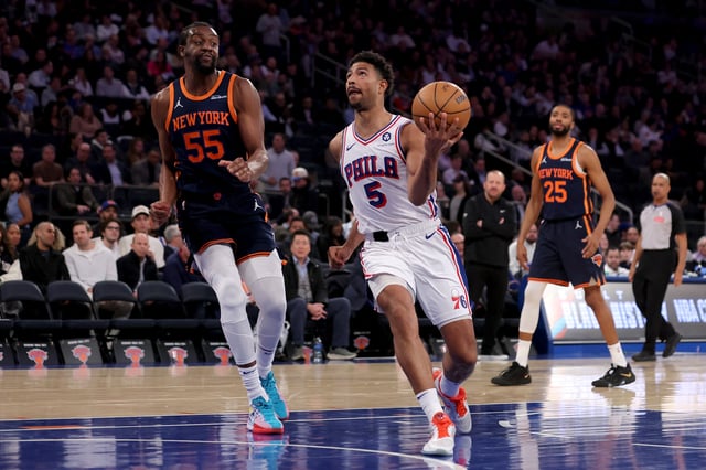 Feb 26, 2025; New York, New York, USA; Philadelphia 76ers guard Quentin Grimes (5) drives to the basket against New York Knicks center Ariel Hukporti (55) and forward Mikal Bridges (25) during the third quarter at Madison Square Garden. Mandatory Credit: Brad Penner-Imagn Images
