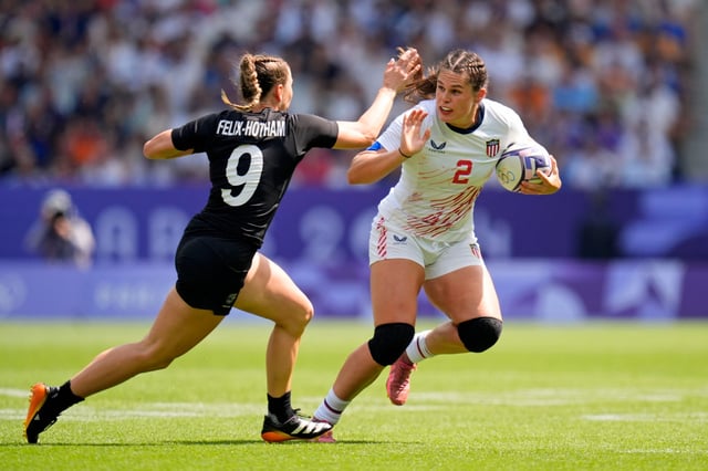 United States forward Ilona Maher (2) runs with the ball against New Zealand back Jazmin Felix-Hotham (9) during the Paris 2024 Olympic Summer Games at Stade de France.