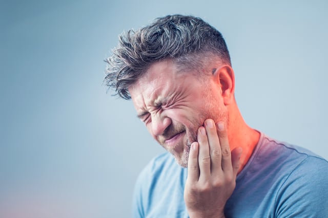 Stock image of a man with toothache.