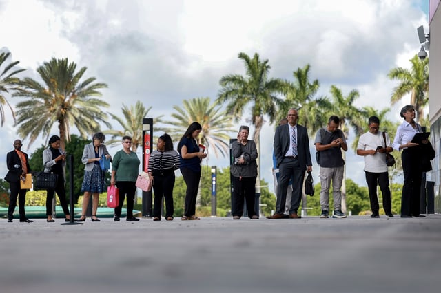 People line up as they wait for the JobNewsUSA.com South Florida Job Fair to open at the Amerant Bank Arena on June 26, 2024, in Sunrise, Florida. 