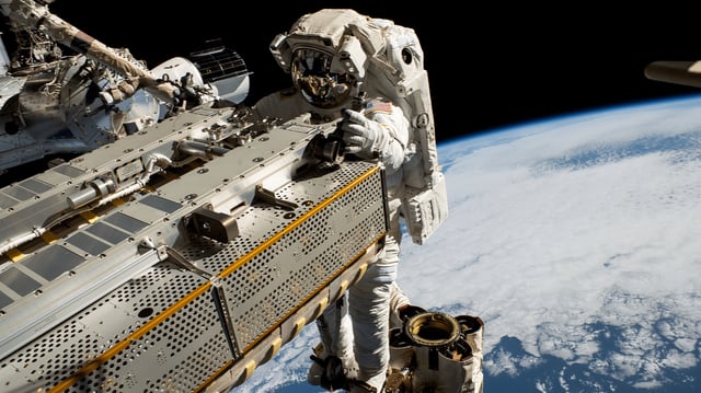 NASA astronaut and Expedition 68 Flight Engineer Woody Hoburg rides the Canadarm2 robotic arm while maneuvering a roll-out solar array toward the International Space Station’s truss structure 257 miles above the Pacific Ocean. In the rear, is the SpaceX Dragon crew vehicle that docked to the Harmony module’s forward port on March 3, 2023 carrying four SpaceX Crew-6 crew members.