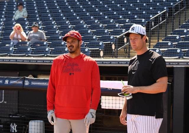 TAMPA, FLORIDA - FEBRUARY 26: Nolan Arenado #28 of the St. Louis Cardinals and Gerrit Cole #45 of the New Yankees chat before a spring training game at George M. Steinbrenner Field on February 26, 2025 in Tampa, Florida.