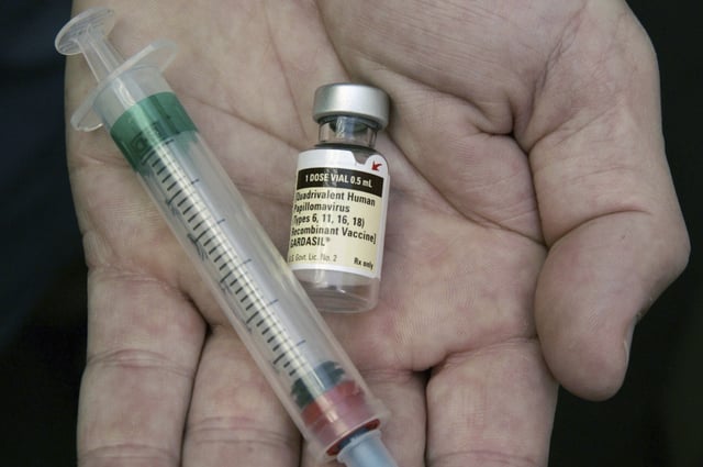 FILE - A doctor holds a vial of the human papillomavirus (HPV) vaccine Gardasil in Chicago on Aug. 28, 2006. (AP Photo/Charles Rex Arbogast, File)