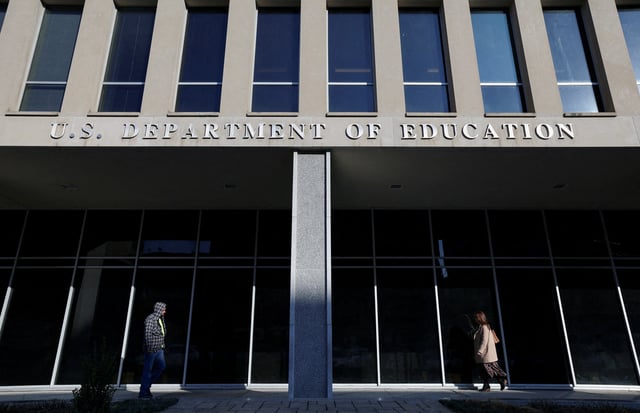 People walk in front of the Department of Education building in Washington, U.S., February 4, 2025. REUTERS/Kevin Lamarque/File Photo