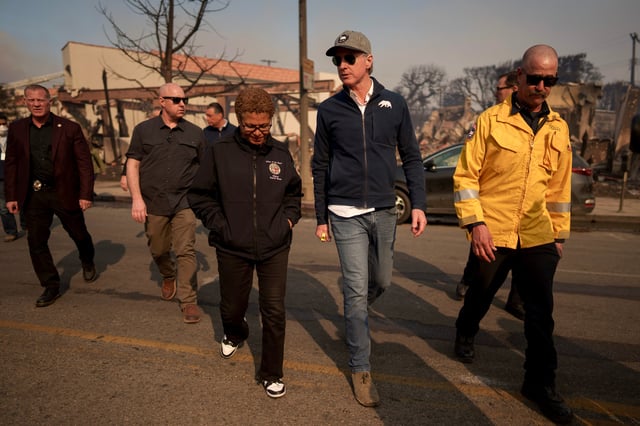 Los Angeles Mayor Karen Bass, center, and California Gov. Gavin Newsom tour the downtown business district of Pacific Palisades on Jan. 8, 2025.