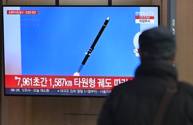 A man is pictured watching a television screen showing news footage of North Korea&#39;s latest test-launch of strategic cruise missiles at a train station in Seoul, South Korea on February 28, 2025.