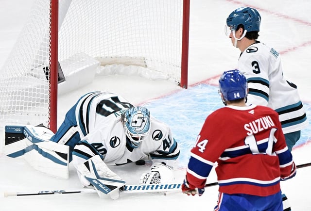 San Jose Sharks goaltender Alexandar Georgiev is scored on by Montreal Canadiens' Nick Suzuki (14) as Sharks' Henry Thrun (3) looks on during first period NHL hockey action in Montreal, Thursday, February 27, 2025. THE CANADIAN PRESS/Graham Hughes